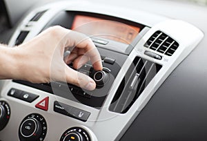 Man using car audio stereo system