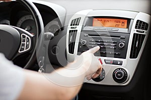 Man using car audio stereo system