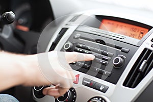 Man using car audio stereo system