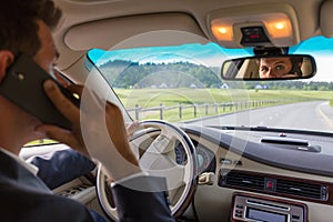 Man using cell phone while driving