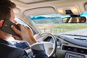 Man using cell phone while driving