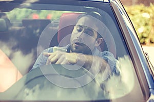 Man using cell phone texting while driving. Reckless driver concept photo