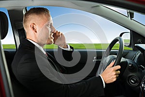 Man using cellphone while driving