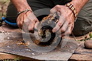 Man using chaga mushroom to keep fire alive