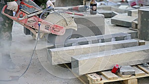 Man using circular saw to cut concrete blocks for building material