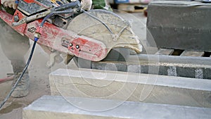 Man using circular saw to cut concrete blocks at construction site