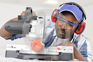 man using circular saw in workplace