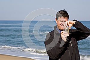 Man using compact camera photo