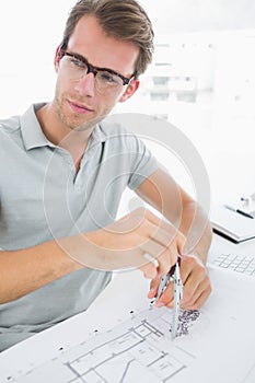 Man using compass on design