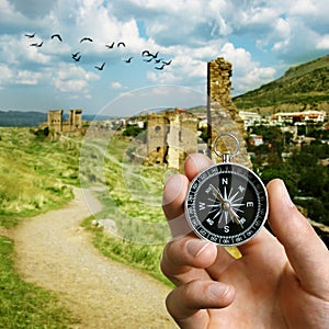 Man using a compass while sightseeing abroad