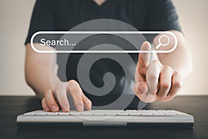 Man using computer keyboard for searching and browsing internet information. Man touching search bar on website. Computer data