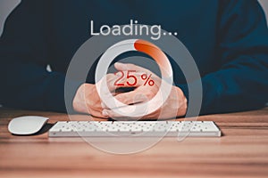 Man using a computer keyboard to download and waiting to loading digital business data form website.