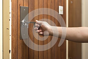 Man using a contactless tool to press a button, to avoid the Covid-19 contagion