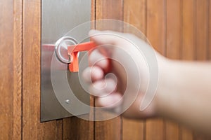 Man using a contactless tool to press a button, to avoid the Covid-19 contagion