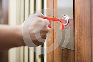 Man using a contactless tool to press a button, to avoid the Covid-19 contagion