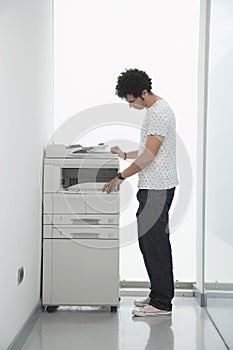 Man Using Copy Machine In Hallway