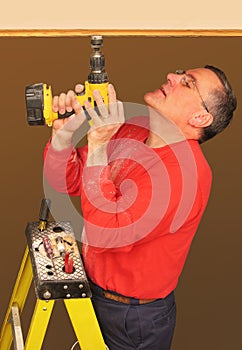 Man using cordless electric drill