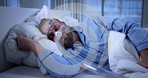 Man Using CPAP Machine Mask