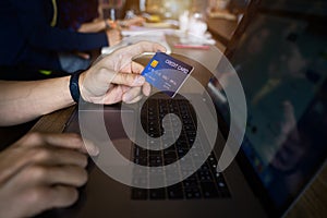 Man using credit card payment shopping online in public cafÃ©. Internet data fraud risk