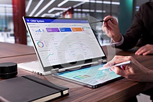 Man Using CRM Software On Laptop