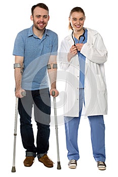 Man using crutches, next to a friendly physician
