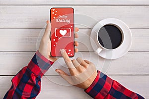 Man Using Dating Application On Smartphone And Drinking Coffee