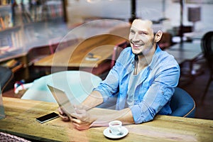 Man using digital tablet at cafe photo