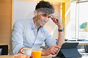 Man using digital tablet at coffee bar