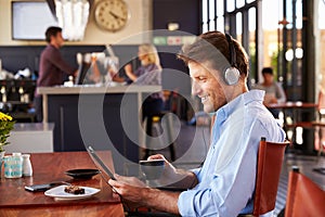 Man using digital tablet in a coffee shop