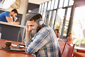 Man using digital tablet in a coffee shop