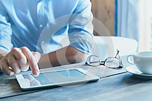 Man using digital tablet computer, close up of the hand