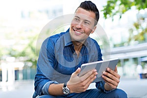 Man using digital tablet outdoors