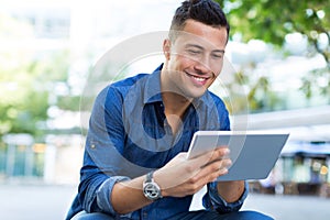 Man using digital tablet outdoors