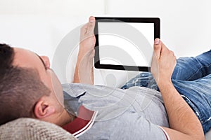 Man Using Digital Tablet On Sofa