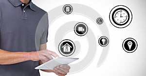 Man using digital tablet with various icons in background