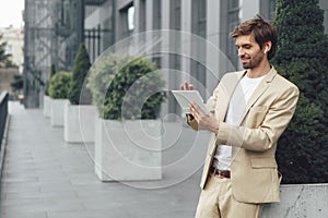 Man using digital tablet for video conversation on street