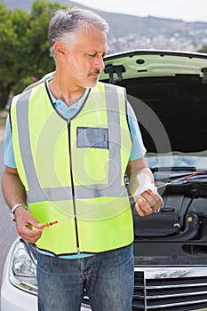 Man using dipstick to check oil
