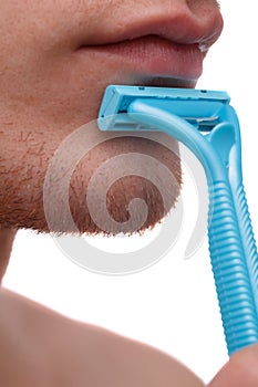 Man using a disposable razor, isolated on white background.