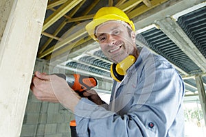 man using electric drill