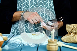 Man using electronic tablet pc in kitchen for baking.