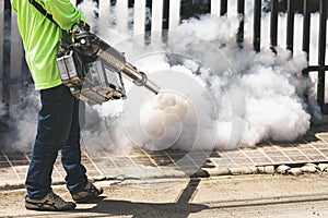 Man using fogger machine to control dangerous from mosquitoes