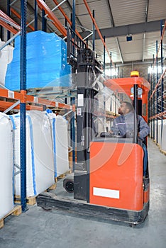 Man using forklift in warehouse