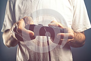 Man using game pad controller to play video games