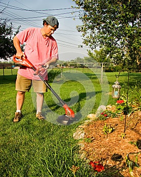 Man Using Grass Trimmer photo