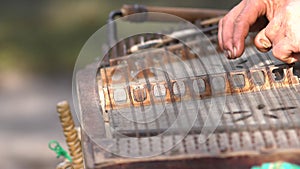 Man using hammered mallets to play a zither