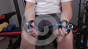 Man using hand expanders for wrist