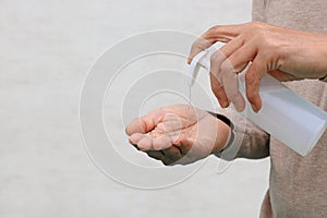 Man using hand press bottle and pouring alcohol-based sanitizer on other hands