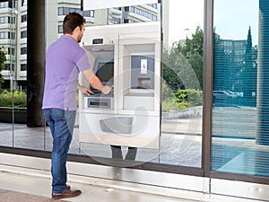 Man using his credit card in an atm for withdrawal