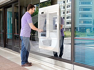 Man using his credit card in an atm for withdrawal