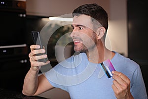 Man using his credit card to shop online